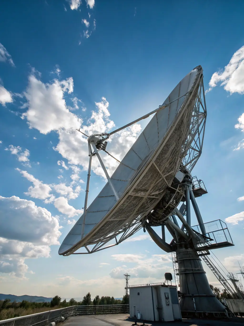 A satellite dish pointed towards the sky, with a digital overlay showing data packets being transmitted, representing the use of TCP M-AT in satellite communication for improved bandwidth utilization.